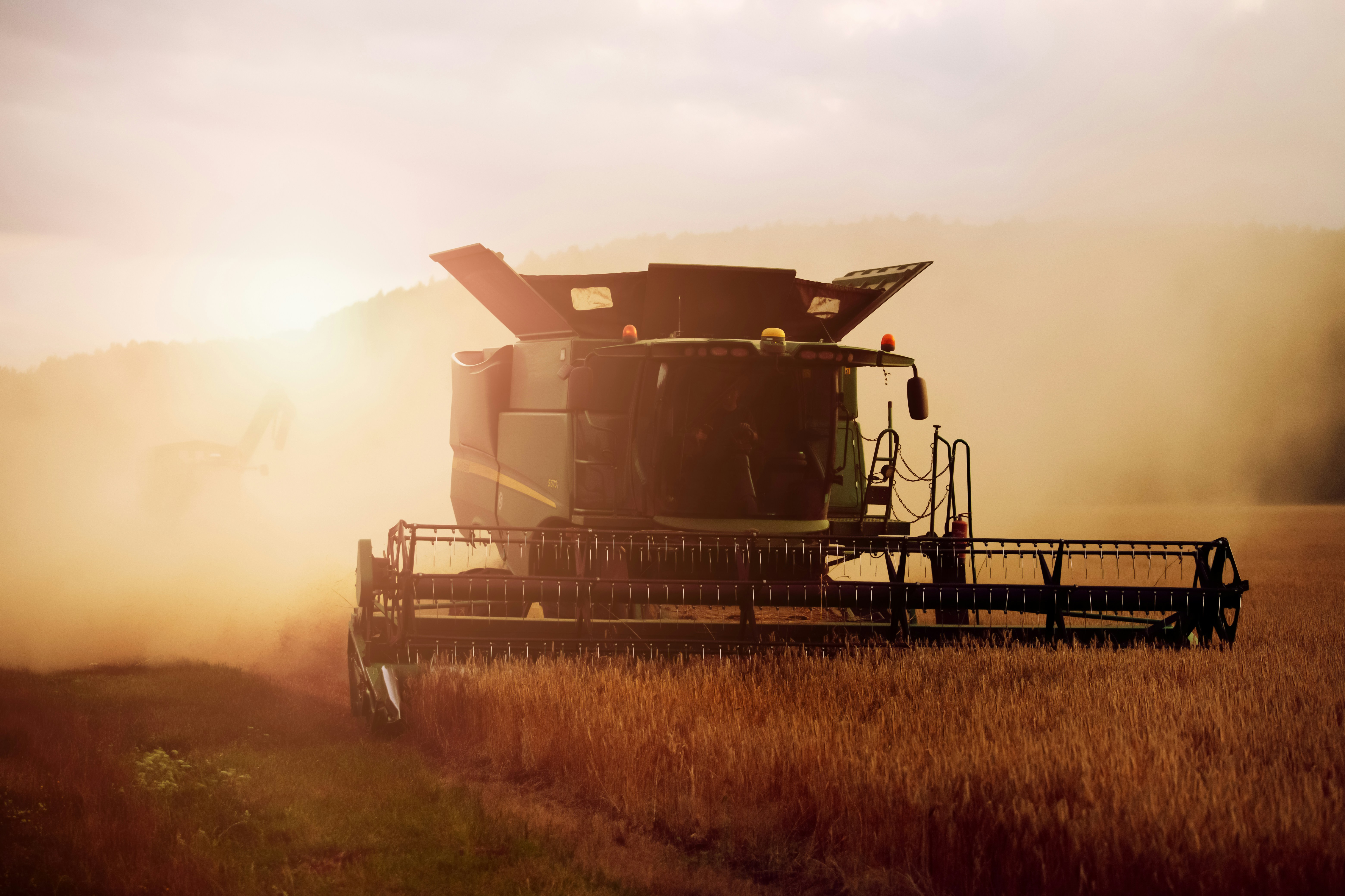a tractor farm equipment, doing work on crops
