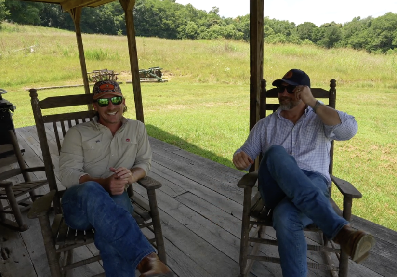 Broker walking field with landowner — editorial style, warm tones